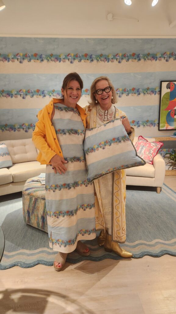 Jill Seale and Caroline Hipple showcasing Norwalk's custom Siesta Key wallpaper and fabric
